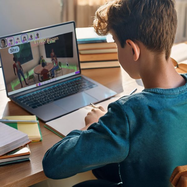 Student using MetaLingo platform on laptop for interactive avatar-based online learning